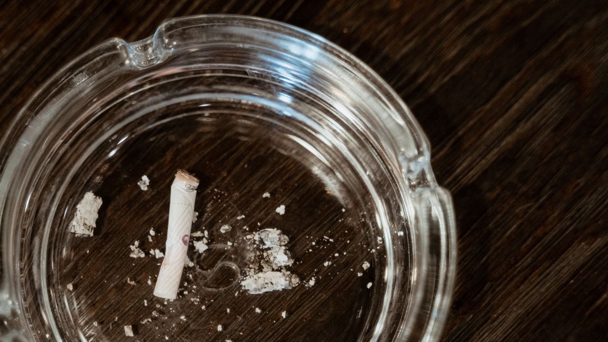 Poslední típnutá cigareta ve skleněném popelníku